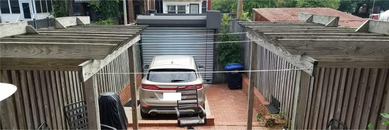 Stainless steel cables with turnbuckles prior to installation of shade panel between two wood shade pergolas