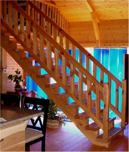 Blue tinted water passive solar fiberglass heat storage tubes coloring the interior house natural lighting