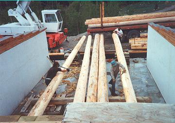 Peeling bark off logs inside the home foundation makes for more effective work area, versus out in yard