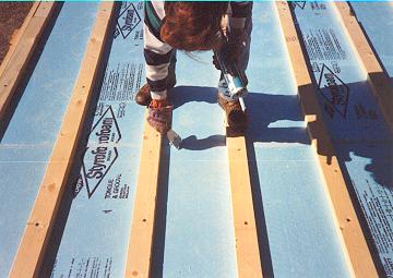 roofdeck4 2by4 sleepers are caulked and then ring-shank spiked through blueboard and into the log purlin below