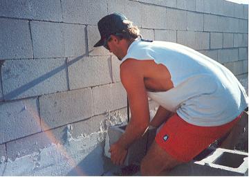 Layer surface bonding cement onto both blocks and then lower into place for a tight fit